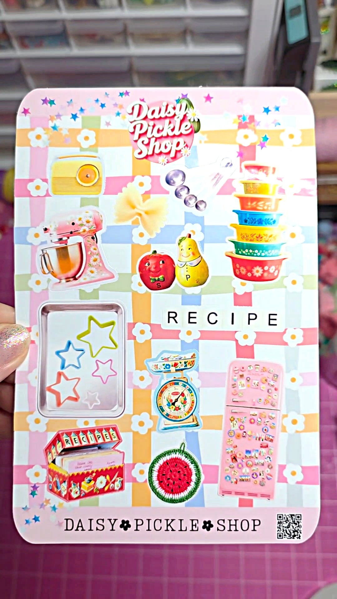 Card with colorful stickers and 'Daisy Pickle Shop' branding on a pink background.