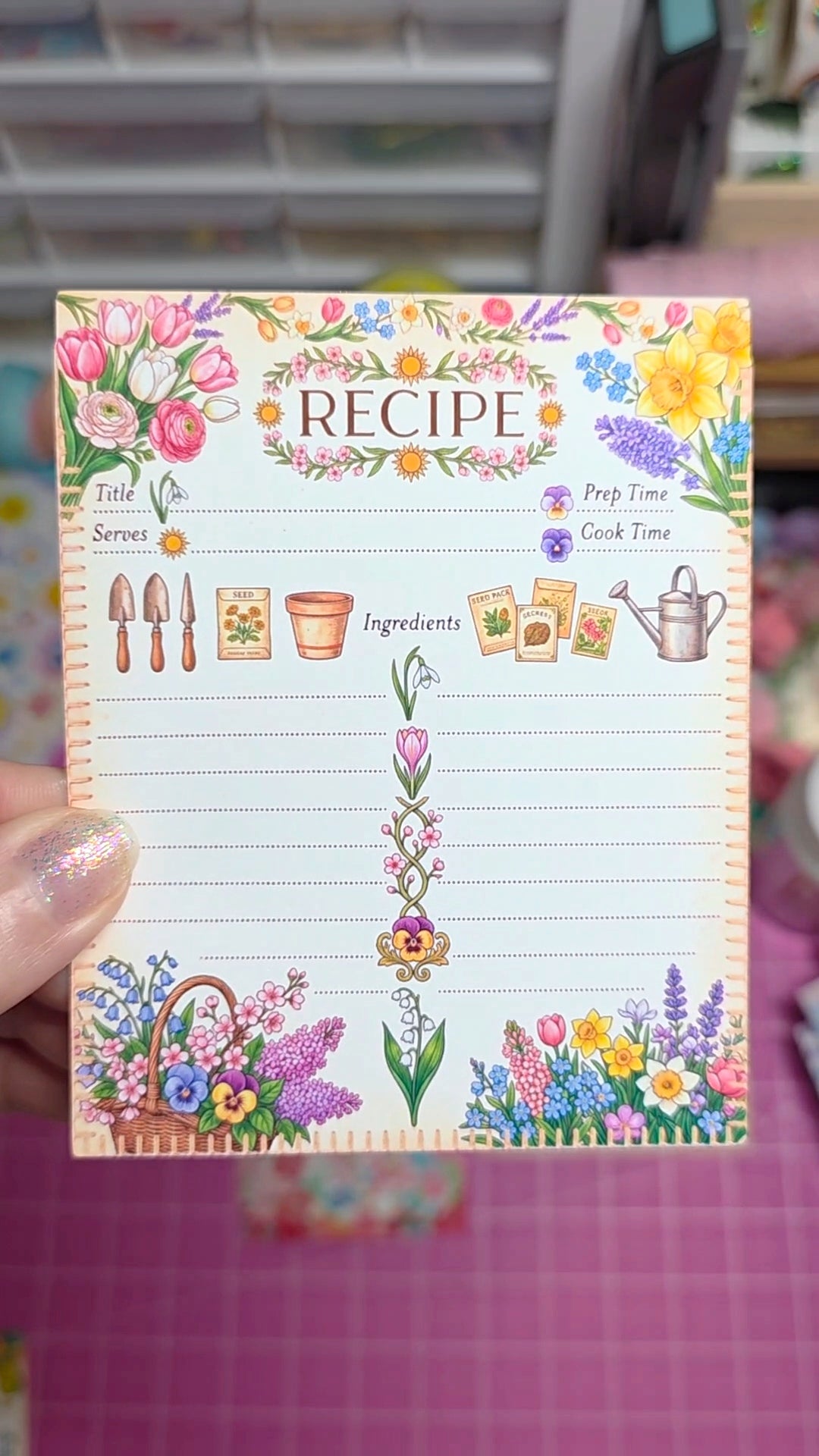 Floral-themed recipe card held by a hand with a blurred background