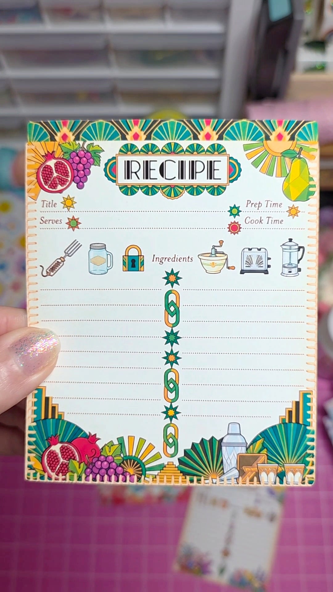 Colorful recipe card held by a hand with a blurred background