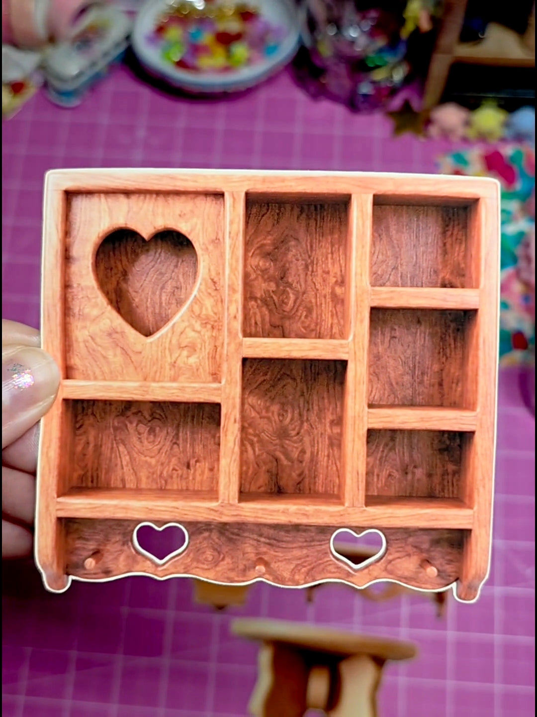 Wooden jewelry box with heart designs on a colorful background