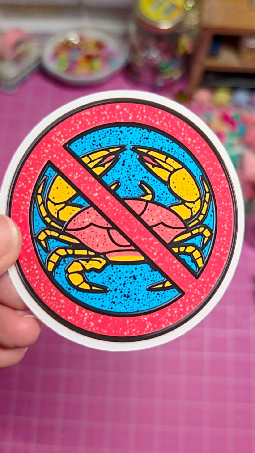 Sticker with a colorful design of a person and a 'no' symbol on a pink background.