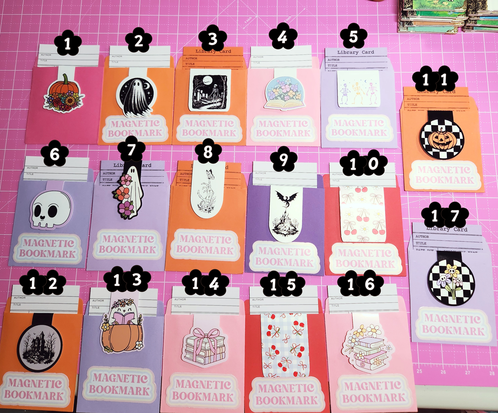 Set of magnetic bookmarks with various designs on a pink grid background
